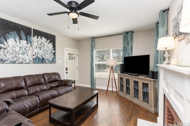 living room with dark hardwood / wood-style flooring and ceiling fan