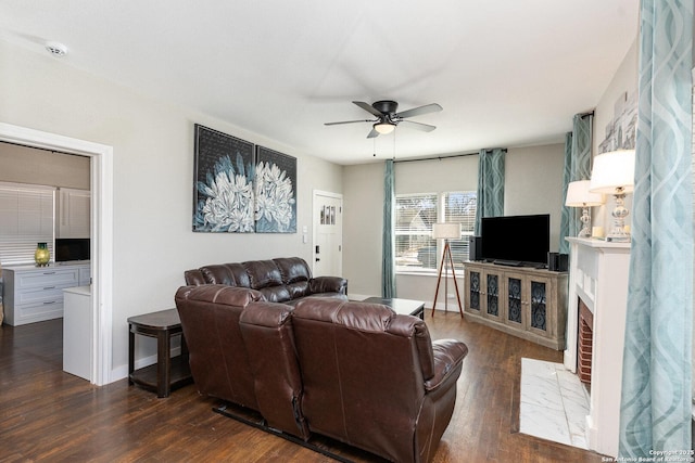 living room featuring ceiling fan and dark hardwood / wood-style floors