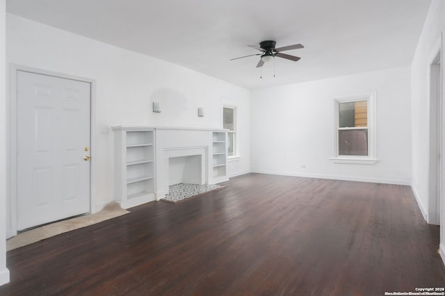 unfurnished living room featuring built in features, dark hardwood / wood-style floors, and ceiling fan