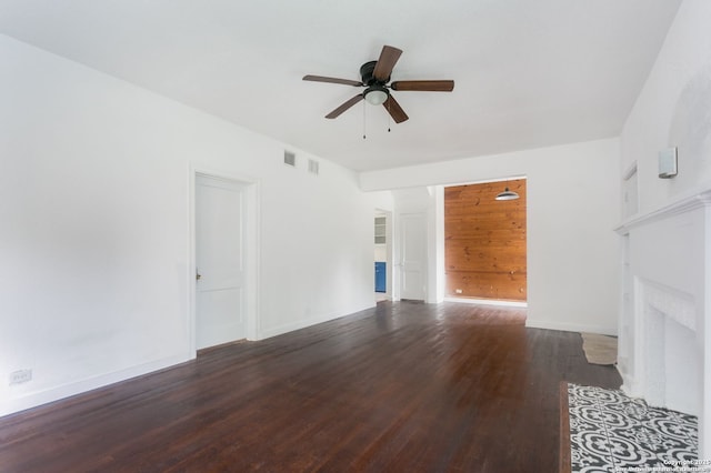 unfurnished living room with ceiling fan and dark hardwood / wood-style flooring