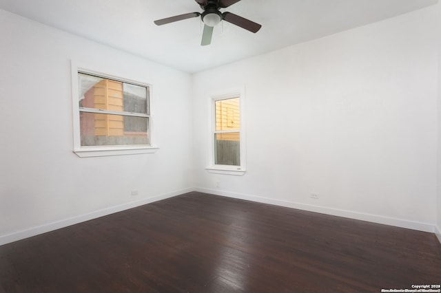 spare room featuring dark hardwood / wood-style floors and ceiling fan