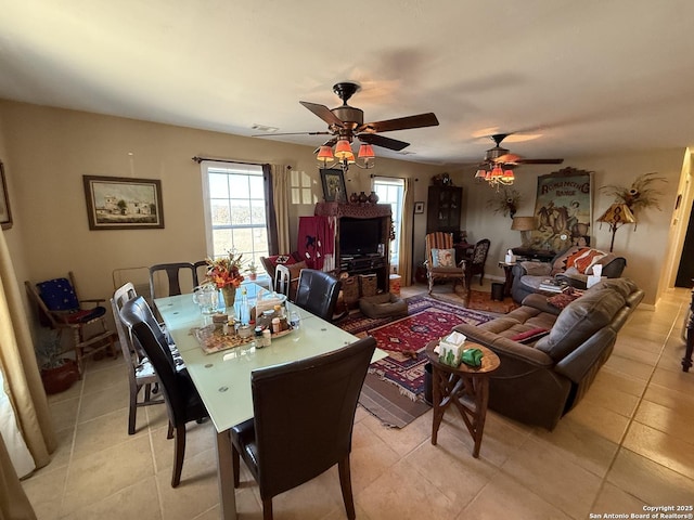 dining space featuring light tile patterned flooring and ceiling fan