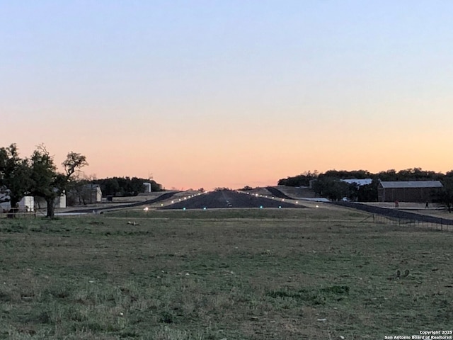 view of yard at dusk