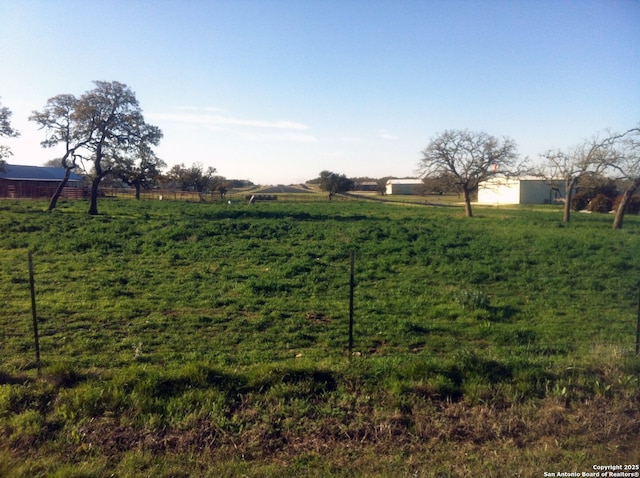 view of yard with a rural view