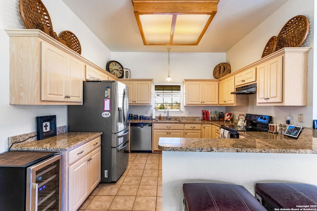 kitchen featuring sink, kitchen peninsula, stainless steel appliances, beverage cooler, and light stone countertops