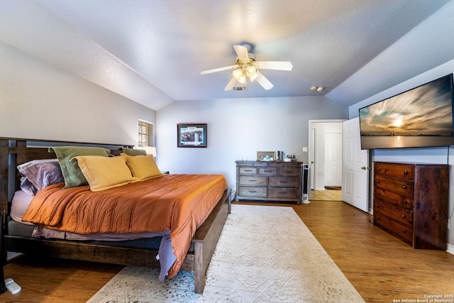 bedroom featuring lofted ceiling, hardwood / wood-style floors, and ceiling fan