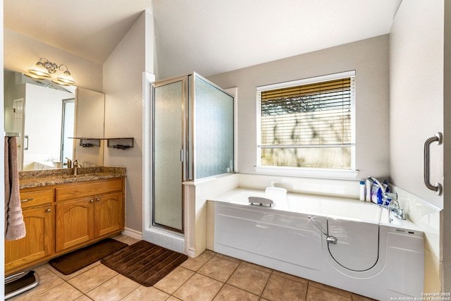 bathroom with plus walk in shower, vanity, and tile patterned floors