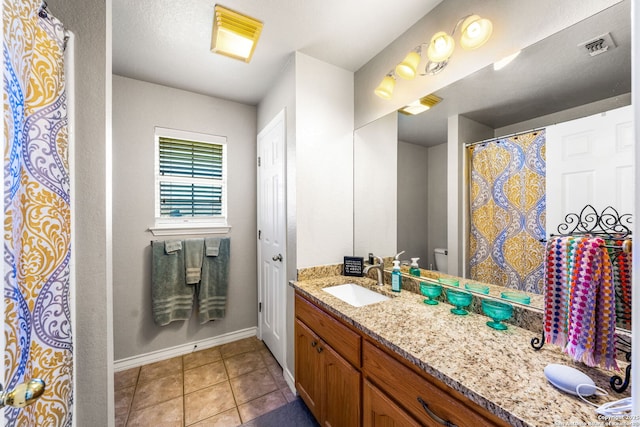 bathroom with vanity, tile patterned floors, and toilet