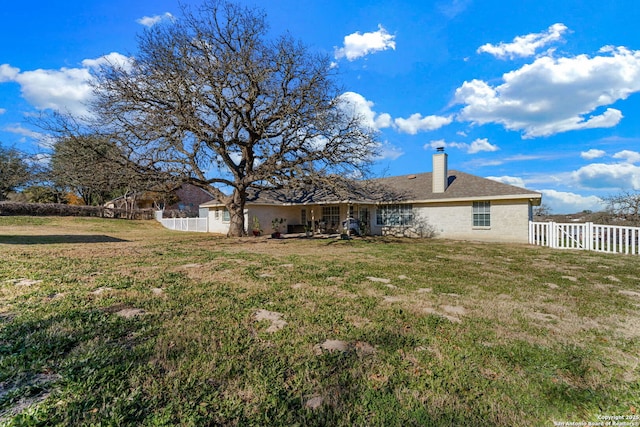 back of property featuring a lawn