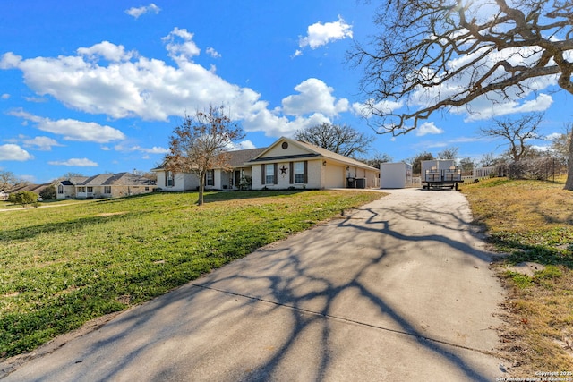 ranch-style home featuring a front yard