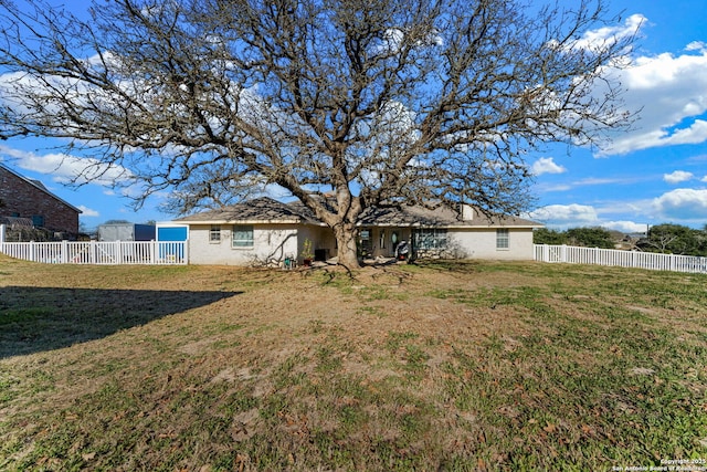 back of property featuring a yard