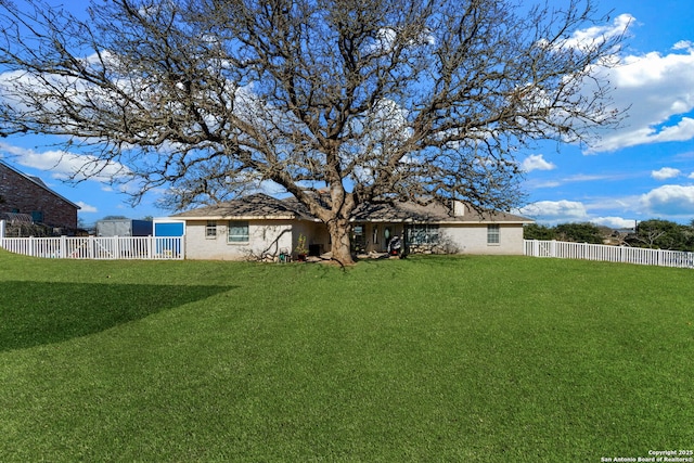 back of house featuring a lawn