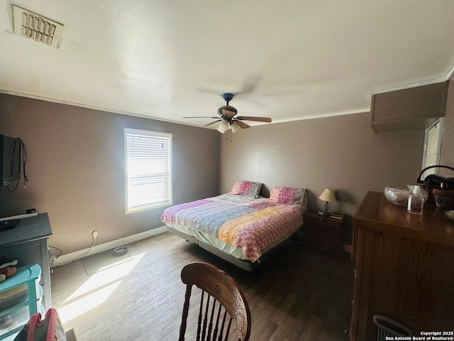 bedroom with hardwood / wood-style flooring, ceiling fan, and ornamental molding