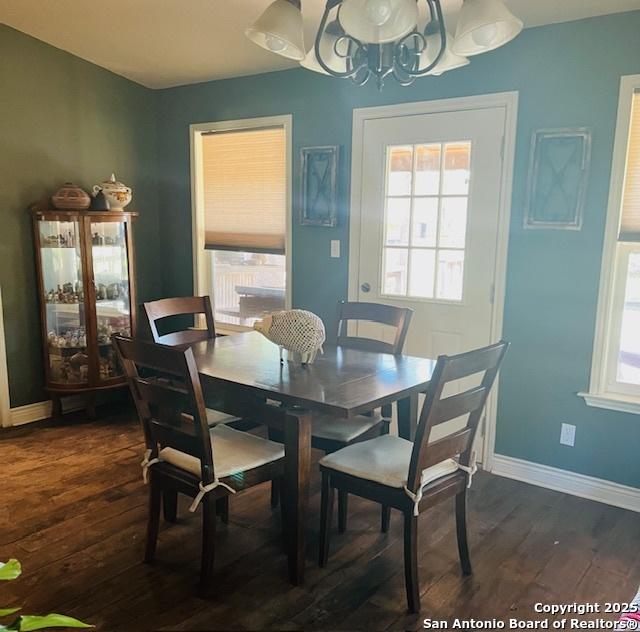 dining room featuring dark hardwood / wood-style floors and a chandelier