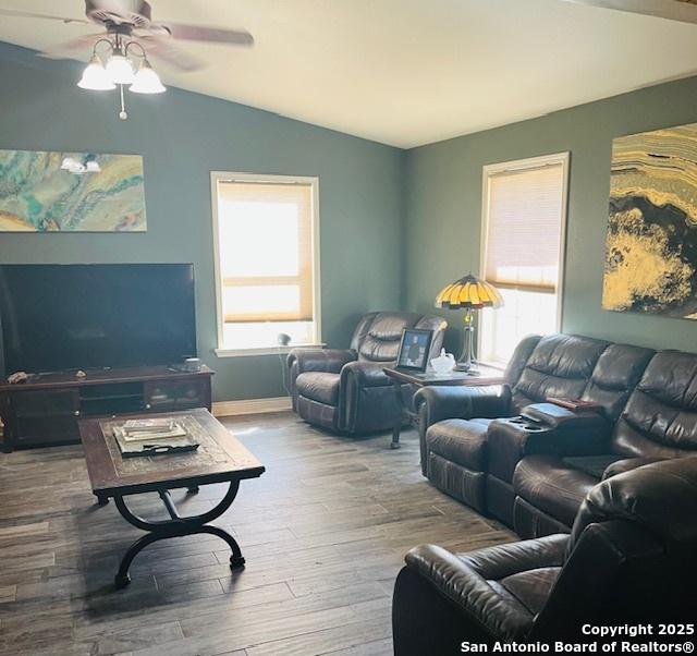 living room featuring lofted ceiling, ceiling fan, hardwood / wood-style flooring, and a healthy amount of sunlight