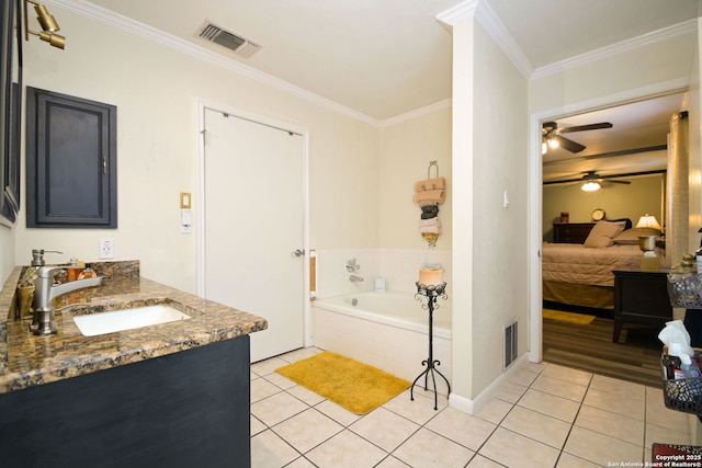 bathroom with crown molding, tile patterned floors, tiled bath, and vanity