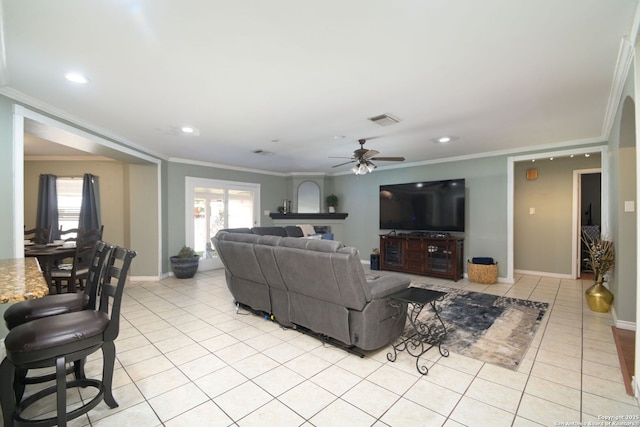 tiled living room with ornamental molding and ceiling fan