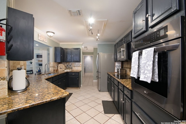 kitchen featuring light tile patterned flooring, sink, crown molding, appliances with stainless steel finishes, and dark stone counters