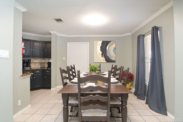 dining room with ornamental molding and light tile patterned floors