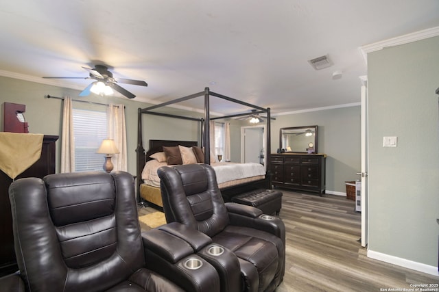 bedroom with ceiling fan, ornamental molding, and hardwood / wood-style floors