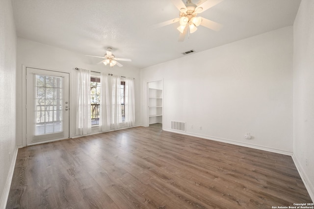 empty room featuring dark hardwood / wood-style flooring and ceiling fan