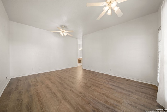 empty room featuring dark wood-type flooring and ceiling fan