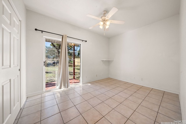 spare room with ceiling fan and light tile patterned flooring