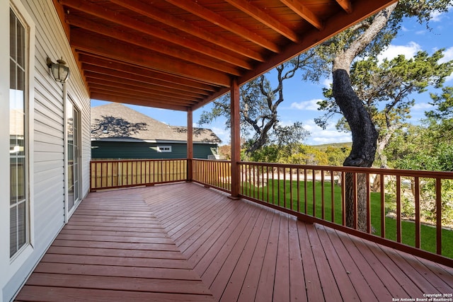 wooden terrace featuring a lawn