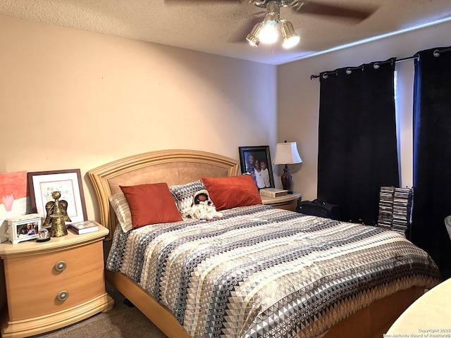 bedroom featuring ceiling fan, carpet, and a textured ceiling