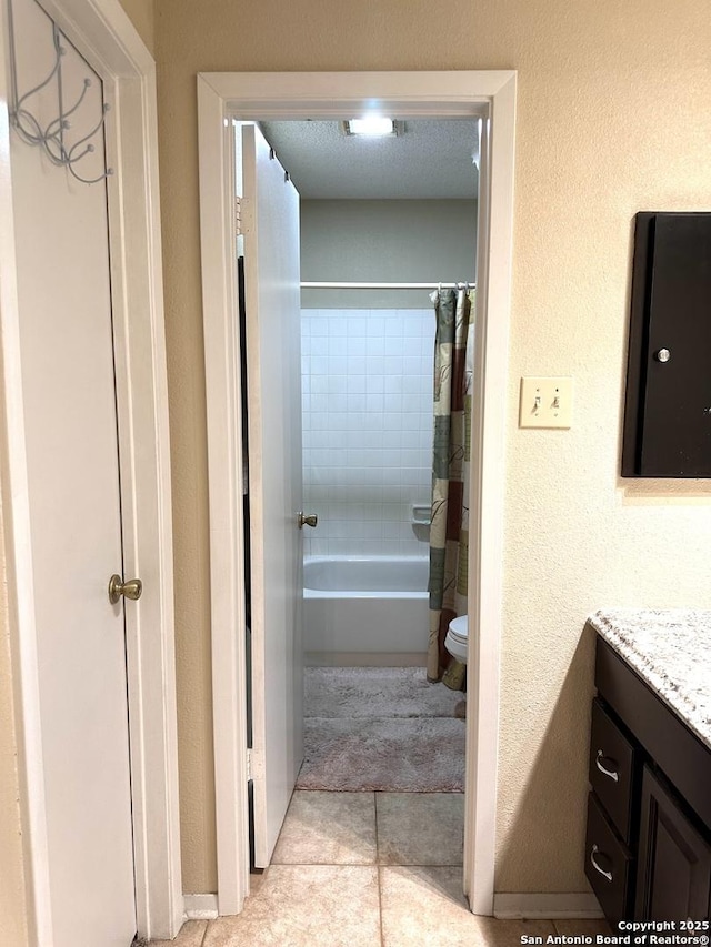 full bathroom with vanity, shower / bath combination with curtain, and toilet