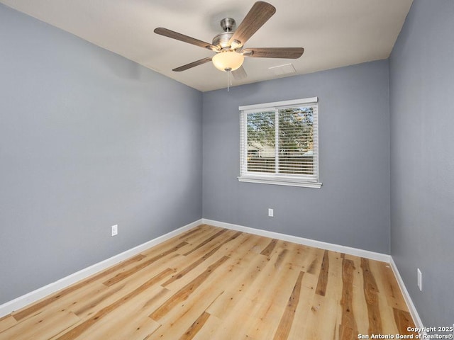 spare room featuring hardwood / wood-style floors and ceiling fan