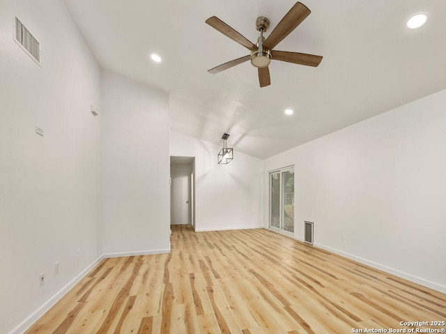 unfurnished living room with ceiling fan, vaulted ceiling, and light hardwood / wood-style flooring