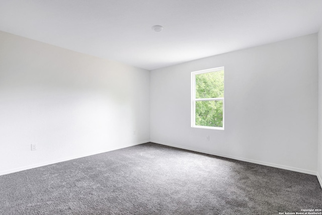 empty room with dark carpet