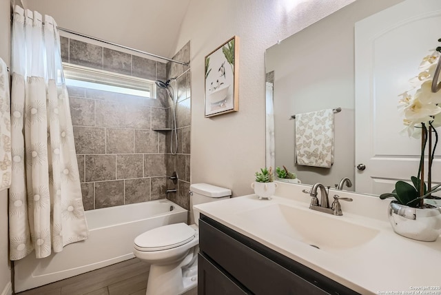 full bathroom featuring hardwood / wood-style flooring, shower / tub combo with curtain, vanity, and toilet