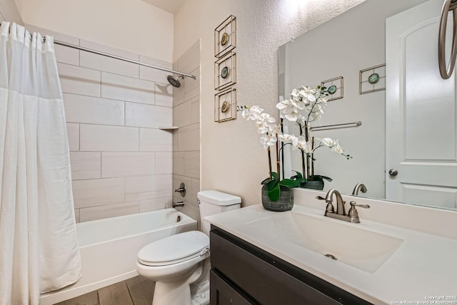 full bathroom with shower / tub combo with curtain, vanity, hardwood / wood-style floors, and toilet