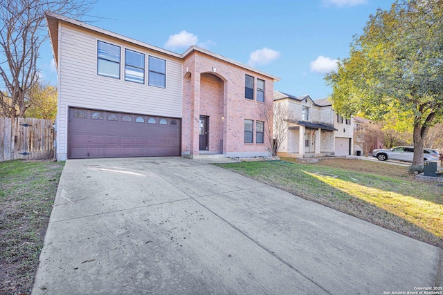 view of property with a garage and a front yard