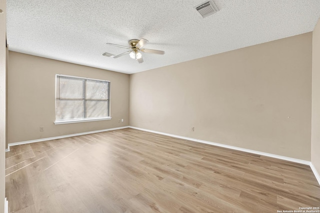 spare room featuring a textured ceiling, light hardwood / wood-style floors, and ceiling fan