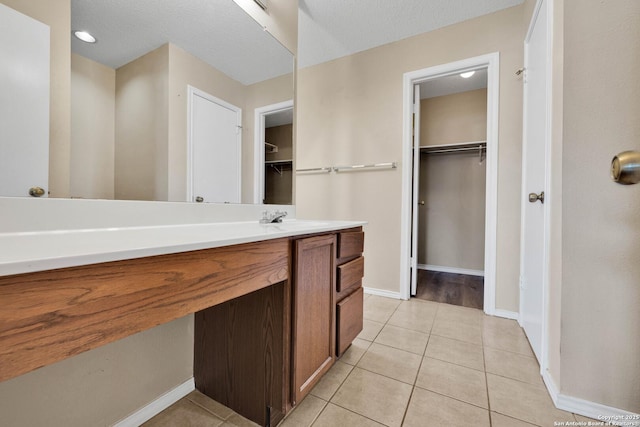 bathroom with tile patterned flooring and vanity