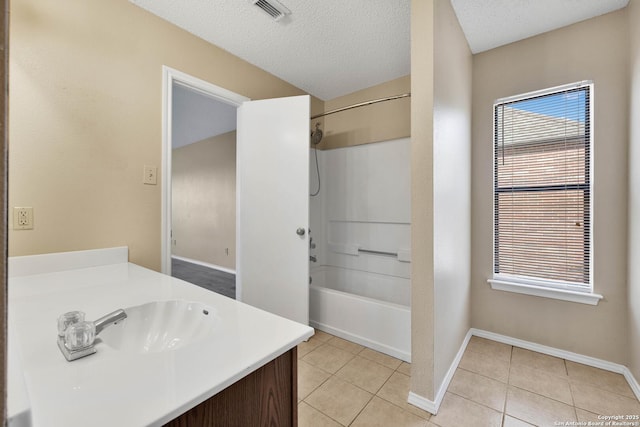 bathroom with vanity, tile patterned floors, a textured ceiling, and shower / bathing tub combination