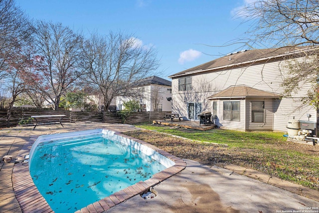 view of pool featuring a yard and a patio