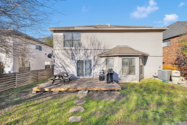 rear view of house featuring a yard, central air condition unit, and a deck