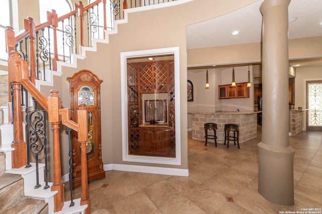 foyer entrance featuring decorative columns