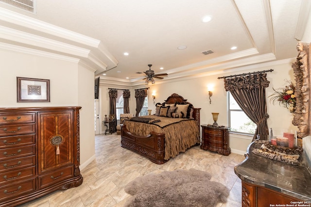 bedroom with ornamental molding and a raised ceiling