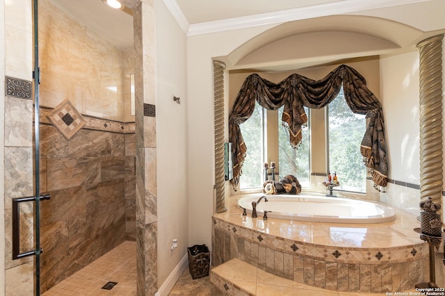 bathroom with ornamental molding and separate shower and tub