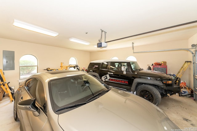 garage featuring a garage door opener and electric panel