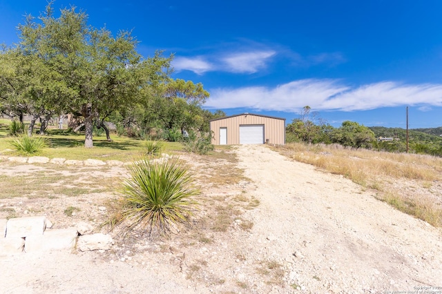 view of front of home featuring a garage and an outdoor structure