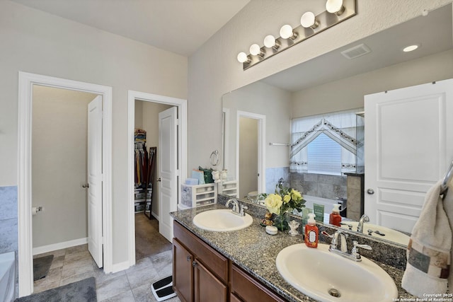 bathroom with vanity and a washtub