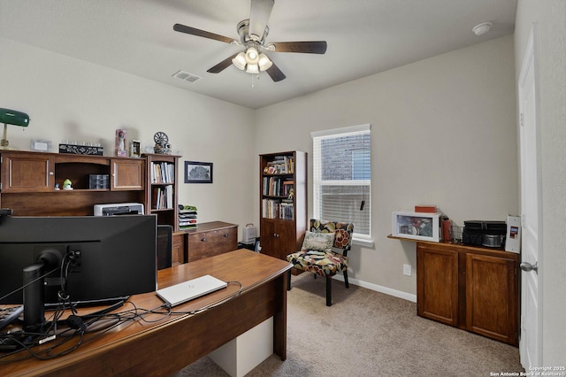 home office featuring light carpet and ceiling fan