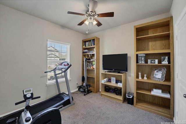 workout area featuring ceiling fan and light carpet