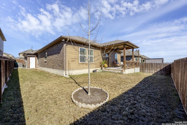 back of property featuring a patio and a yard